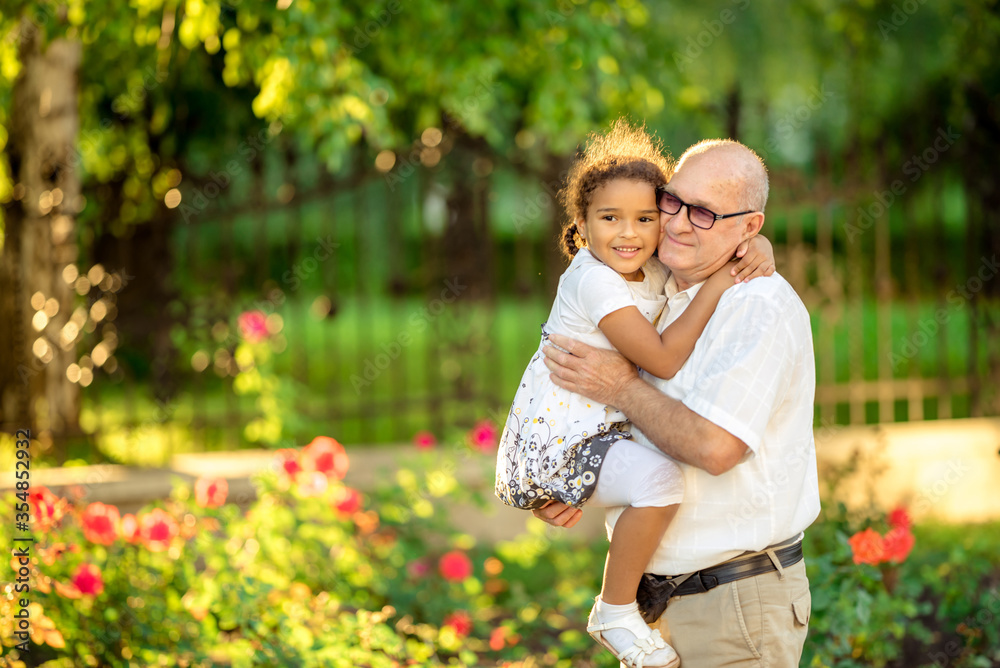 Little granddaughter hugging her grandfather Little granddaughter hugging her grandfather