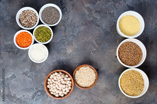 Superfoods and cereals selection in bowls on grey concrete background