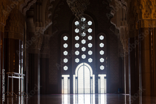 the daily life of different people at the Hassan II Mosque in Casablanca, the pray, talk, and spent time together on a normal summer day.  The mosque has unique and Arabic doors and towers
