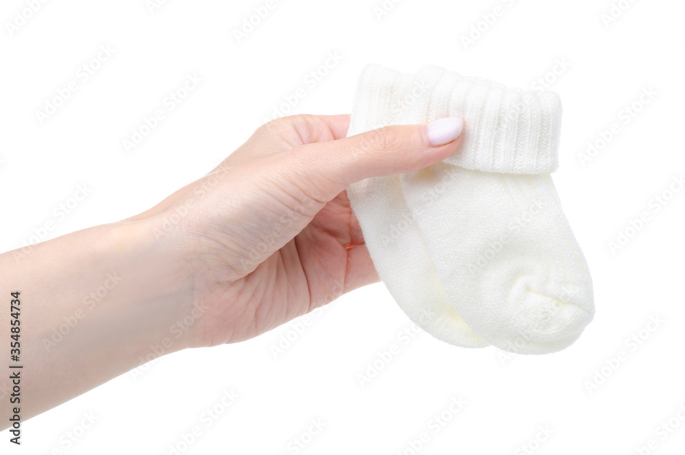 White socks for newborn child baby in hand on white baclground isolation White socks for newborn child baby in hand on white baclground isolation