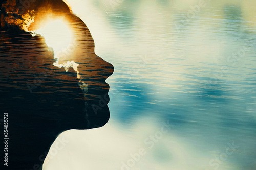 Woman silhouette with sun in head with copy space. Multiple exposure image. photo