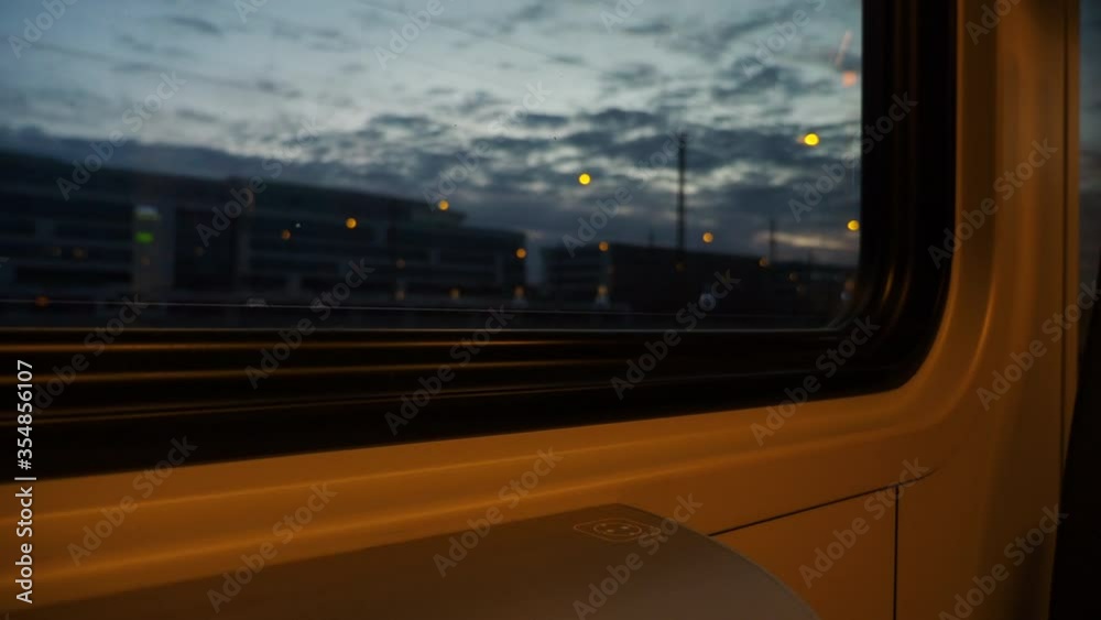 Passenger view through the window of a train waiting on a station.