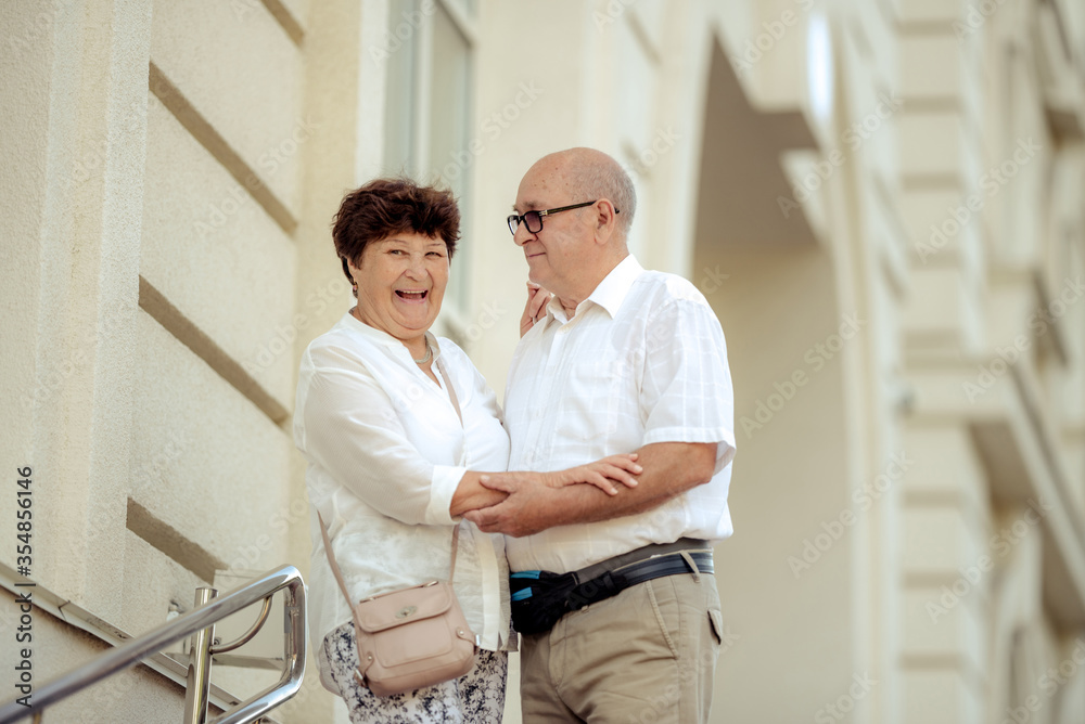 Fototapeta premium Handsome old man and attractive old woman are hugging