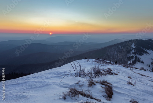 Landscape of winter Carpathians. Beskids region. The moment of sunrise. Moments before sunrise in misty Carpathian mountains