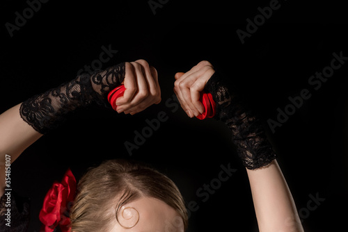 cropped view of flamenco dancer holding castanets isolated on black