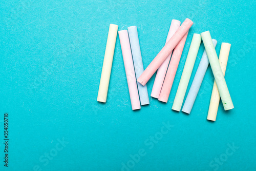 Colors chalk sticks on blue background 