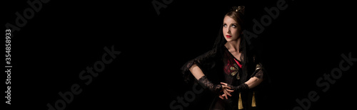 panoramic concept of pretty young flamenco dancer standing isolated on black
