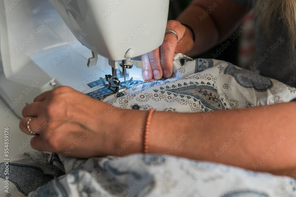 Woman's hands working with a sewing machine