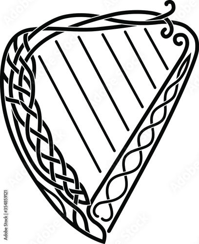 Celtic harp with patterns, black and white image, musical instrument.