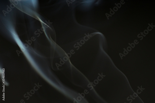 Smoke scented candles on a black background