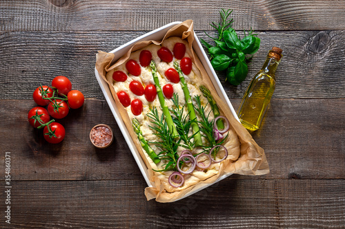 Trendy art garden Focaccia bread dough preparing to bake. wooden table, top view.