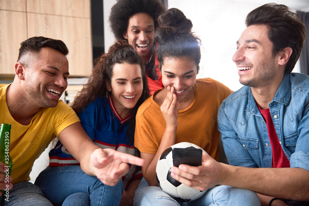 Group of friends watching something funny on the phone Group of friends watching something funny on the phone