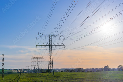 Strommasten stehen auf einem Feld auf dem Land