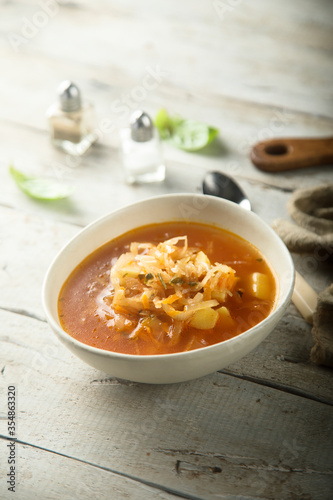 Traditional homemade sauerkraut soup in a white bowl