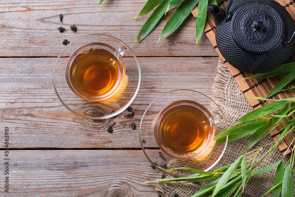 Cup of hot green tea on a wooden table Cup of hot green tea on a wooden table