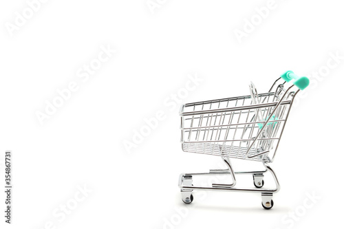 Miniature empty shopping cart on white background