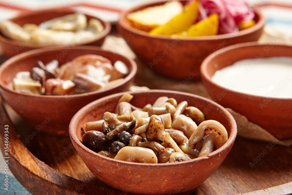 Snack assortment on wooden tray side view Snack assortment on wooden tray side view