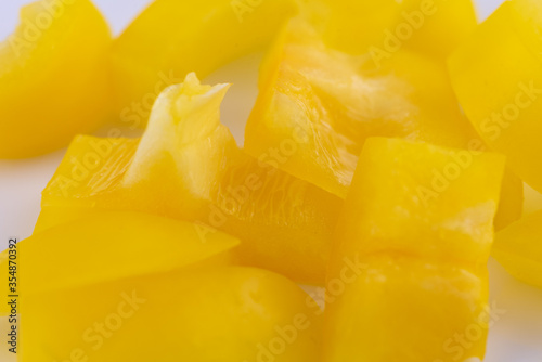 Macro close up of chopped yellow bell pepper.