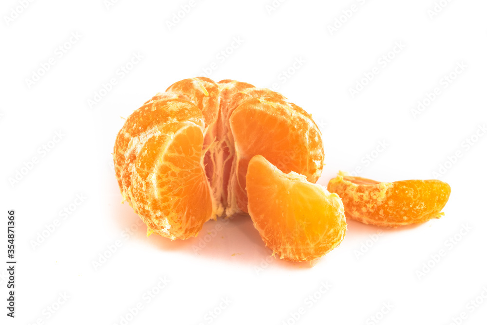 Satsuma Mandarinebeing unpeeled and quartered, isolated on a white background,