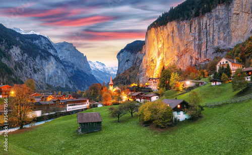 Dramatic autumn view of Lauterbrunnen valley with gorgeous Staubbach waterfall and Swiss Alps at sunset time