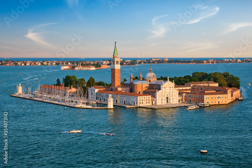 Famous Italy tourist destination - aerial view of Venice lagoon and San Giorgio di Maggiore church with boats and vaporetto traffic on sunset from St Mark's Campanile bell tower, Venice, Italy © Dmitry Rukhlenko