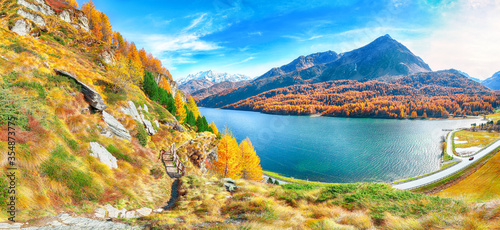 Gorgeous autumn scene over Maloya village and Sils Lake (Silsersee).