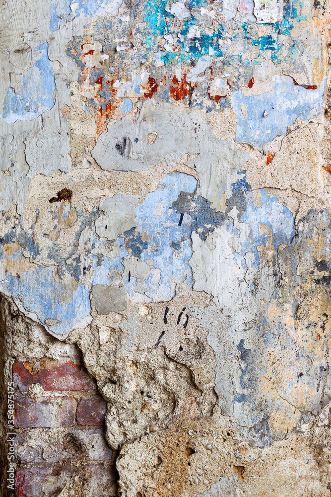 Creative background of rusty metal, painted gray paint carelessly with the remnants of torn paper. Grungy metal surface. Great background or texture for your project.