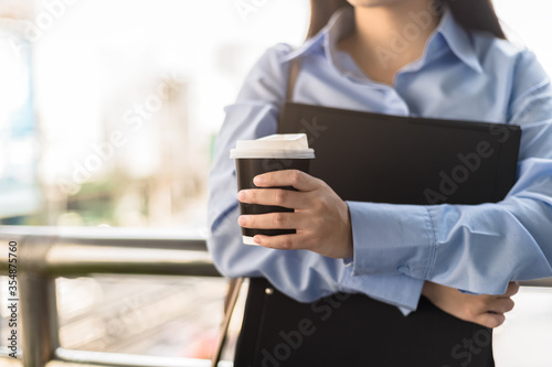 Beautiful Woman hold cup of coffee in the morning.