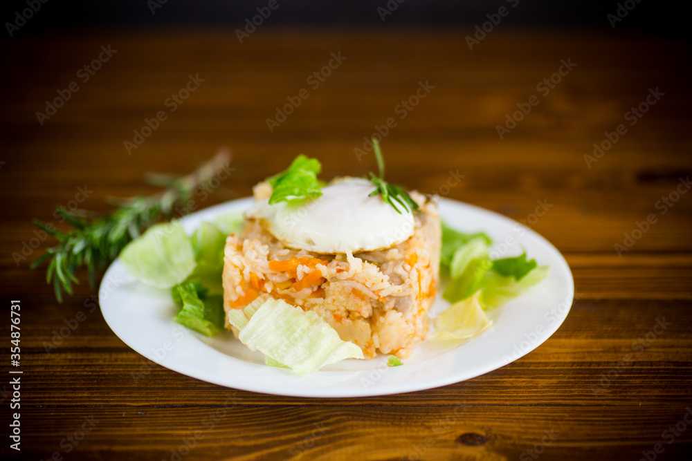 boiled rice with vegetables and fried egg with salad leaves in a plate boiled rice with vegetables and fried egg with salad leaves in a plate
