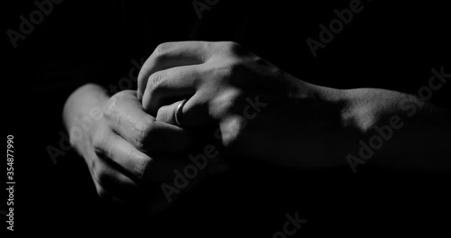 Fingers twirl the wedding ring, abstraction