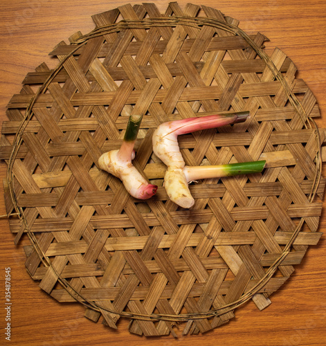 Galangals are placed on bamboo weave, top view.