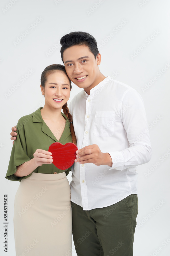 young love couple holding red heart, happy smile embrace, isolated over white background, valentine day concept young love couple holding red heart, happy smile embrace, isolated over white background, valentine day concept