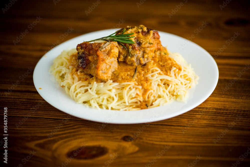 boiled vermicelli with meat and gravy in a plate