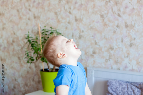 The child's emotions. The little boy laughs hard. Children.