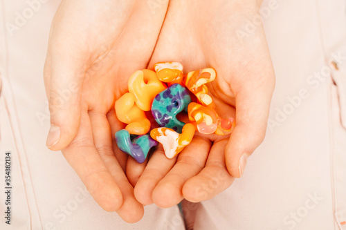 Photography Different types of ear plugs in female hands, top view