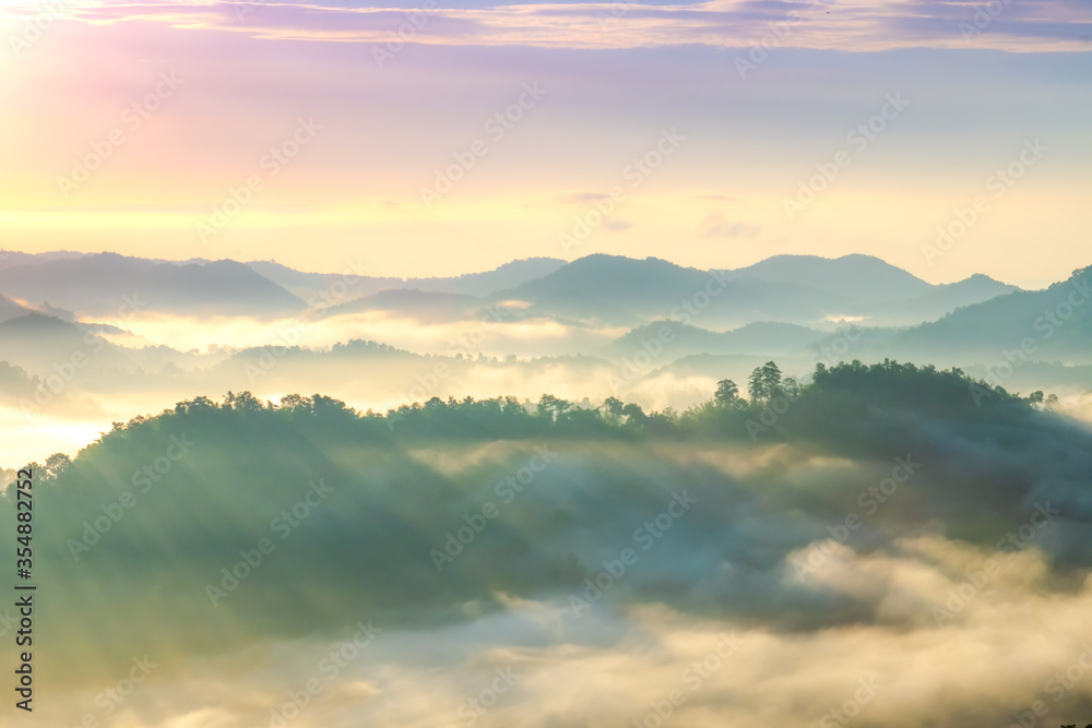 Beautiful Landscape of mountain layer in morning sun ray and winter fog.