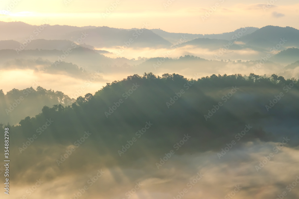 Beautiful Landscape of mountain layer in morning sun ray and winter fog.