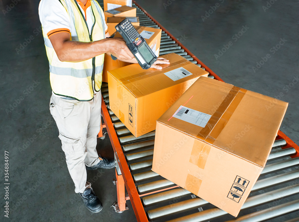 Workers Scanning Bar Code Scanner on Packaging Boxes. Shipping