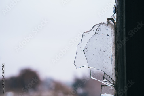 Detail of a broken glass of a window of an abandoned building
