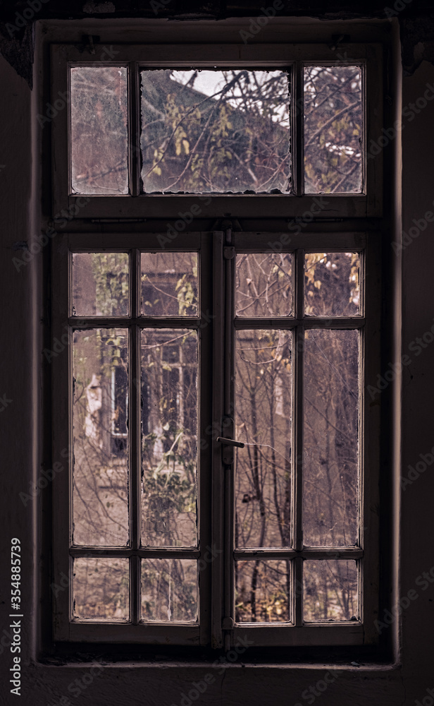 Window of an empty abandoned old building with broken glasses Window of an empty abandoned old building with broken glasses
