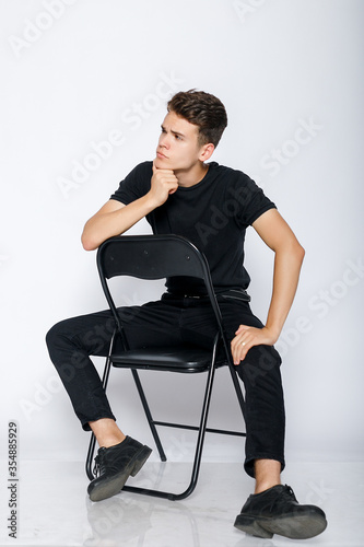 Young muscular man in a black t-shirt and jeans