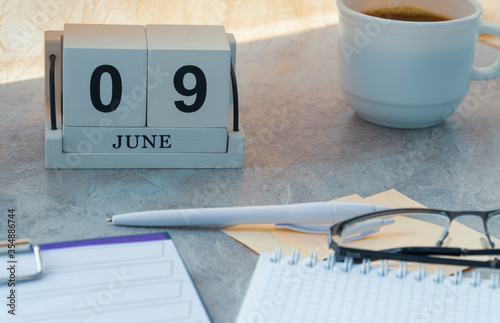 June 09, date on the calendar. Handmade wood cube with date month and day. planning for the day. artistic coloring. selective focus.