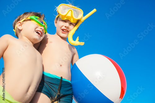 two kids having fun on the beach in summertime