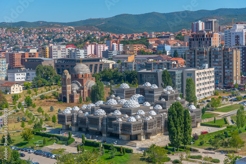 National library of Kosovo and unfinished serbian orthodox church of Christ the Saviour in Prishtina, Kosovo photo