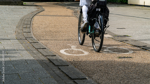 Cyclist riding on bike path in city