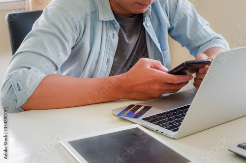 Hands holding credit card and using laptop. Online shopping