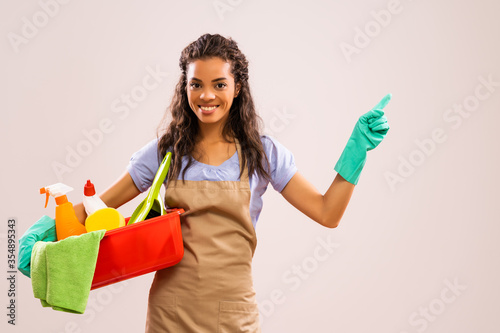 Portrait of african-american professional maid who is ready for housework. photo