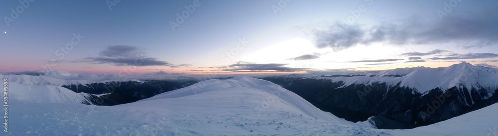 Fototapeta premium snowy mountain with beautiful clouds at high altitude 