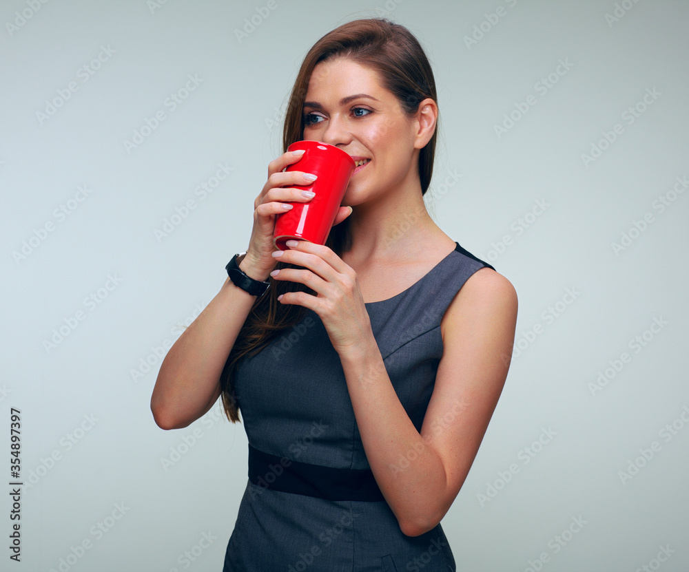 Business woman with dressed business dress holding red coffe cup looking away Business woman with dressed business dress holding red coffe cup looking away