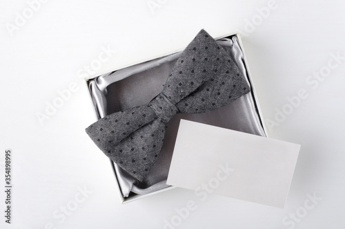 Carta da parati Top view of empty business card, bow tie in the present box